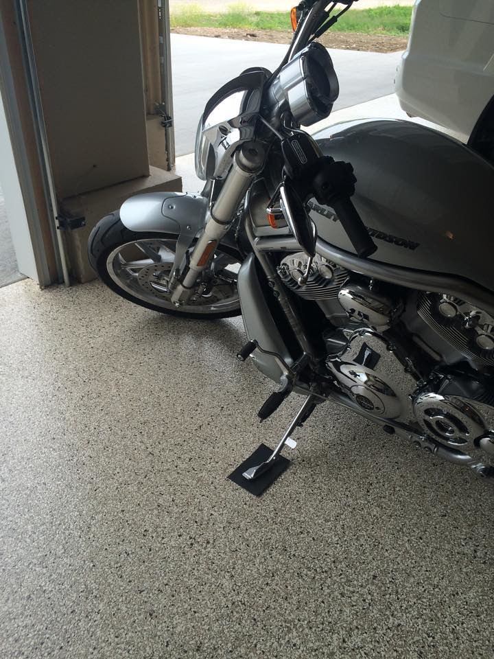Epoxy garage floor with a motorcycle parked on it